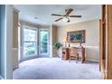 Bright home office featuring large windows, neutral carpet, and elegant crown molding at 1633 Kiawah Ct, Gastonia, NC 28056