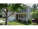 Charming two-story home with a welcoming front porch, well-maintained lawn, and mature trees at 1673 Beleek Ridge Ln, Clover, SC 29710