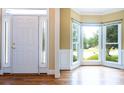 Bright foyer with hardwood floors, white door, sidelights, and a view of the front yard at 2019 Steeplechase Dr, Rock Hill, SC 29732