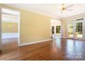 Spacious room featuring hardwood floors, neutral walls, ceiling fan, and an entrance to another room at 2019 Steeplechase Dr, Rock Hill, SC 29732