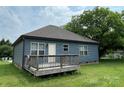 Back exterior showcasing a wooden deck and tidy siding at 210 Rhyne St, Stanley, NC 28164