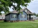 Attractive blue home with neatly kept lawn and classic architectural details at 210 Rhyne St, Stanley, NC 28164