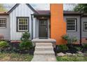 Inviting front entrance with a black front door, concrete steps, and nicely landscaped flower beds at 2628 Clydesdale Ter, Charlotte, NC 28208