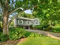 View of the exterior showing the manicured lawn, lovely tree, driveway and an attached two-car garage at 3124 5Th Street Ne Pl, Hickory, NC 28601