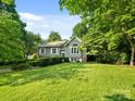 Lush green lawn surrounds the house with mature landscaping creating a picturesque scene at 3124 5Th Street Ne Pl, Hickory, NC 28601