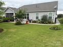 Spacious backyard featuring lush green grass, landscaped flower beds, and an outdoor sitting area at 3145 Bridgewater St, Lancaster, SC 29720