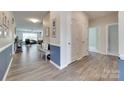 Inviting hallway with wood flooring, neutral paint, and a view into a living area at 3145 Bridgewater St, Lancaster, SC 29720