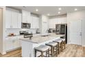 Bright, modern kitchen with a large island, granite countertops and stainless steel appliances at 322 Olympia Way, York, SC 29745