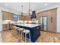 Spacious kitchen boasts a large island with barstool seating, custom cabinetry, and modern stainless appliances at 3903 Plainview Rd, Charlotte, NC 28208