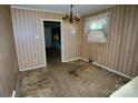 Dining room with dated wallpaper and carpet, presenting an opportunity for renovation and modernization at 402 Villa St, Kannapolis, NC 28083