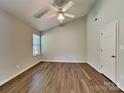 Spacious bedroom featuring laminate flooring, ceiling fan, a vaulted ceiling, and two windows for ample natural light at 4328 Frank Vance Rd, Charlotte, NC 28216