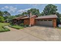 Wood home with a side-entry two-car garage and beautiful landscaping at 4920 Surfwood Dr, Sherrills Ford, NC 28673