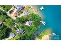Aerial view of lakefront homes with private docks and lush landscaping at 5075 Lakeview Cir, Sherrills Ford, NC 28673