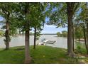 Backyard view with mature trees and boat dock on the lake at 5075 Lakeview Cir, Sherrills Ford, NC 28673