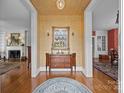 Elegant foyer featuring hardwood floors, a decorative mirror, and ornate light fixtures at 603 S Fulton St, Salisbury, NC 28144