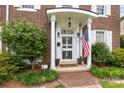 Inviting front porch with white columns, an American flag, and well-maintained landscaping at 603 S Fulton St, Salisbury, NC 28144