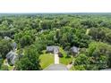 A scenic aerial shot showcases the home's location within a lush, wooded neighborhood, offering privacy and natural beauty at 6908 Beamish Pl, Mint Hill, NC 28227