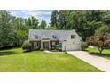A beautifully maintained home with mature landscaping, a two-car garage, and a welcoming entrance at 6908 Beamish Pl, Mint Hill, NC 28227