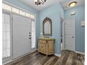Inviting entryway with wood-look flooring, a decorative mirror, and neutral paint creating a warm welcome at 6908 Beamish Pl, Mint Hill, NC 28227
