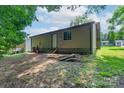 Rear view of home featuring back door access and an unfinished yard at 8019 Walnut Creek Ln, Charlotte, NC 28227