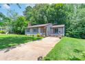 Charming single-story home with a cozy front porch and a well-maintained lawn at 8019 Walnut Creek Ln, Charlotte, NC 28227