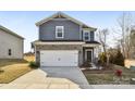 Charming home featuring a stone and gray shingle exterior with a two car garage at 908 Smithcliffs Trl, York, SC 29745