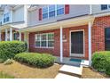 Inviting front porch with red brick, white columns, and a well-maintained lawn at 10032 Pergola View Ct, Charlotte, NC 28213