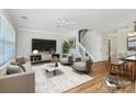 Stylishly furnished living room with a ceiling fan, a decorative rug, and modern décor at 10032 Pergola View Ct, Charlotte, NC 28213