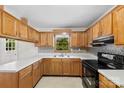 Traditional kitchen features light wood cabinets, white counters, and black appliances at 1156 Westover Cir, Rock Hill, SC 29732