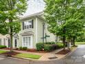 Charming two-story home featuring tidy landscaping and an inviting entrance nestled between mature trees at 13604 Morehouse St, Huntersville, NC 28078