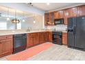 Well-lit kitchen with modern black appliances, stylish cabinets and a bright, laminated floor at 13604 Morehouse St, Huntersville, NC 28078