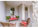 Inviting front porch with comfortable seating and a view of the well-manicured neighborhood at 13708 Huntson Park Ln, Huntersville, NC 28078