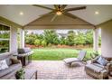 Covered patio with stone pavers, outdoor furniture, and a grill, ideal for outdoor living at 13708 Huntson Park Ln, Huntersville, NC 28078