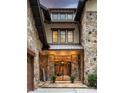 Elegant entrance with a stone facade, wrought iron gate, and manicured greenery at 1501 Alydar Ct, Waxhaw, NC 28173