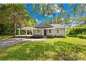Charming one-story home featuring a covered porch, gravel driveway, and verdant lawn at 1528 Avondale Dr, Statesville, NC 28625