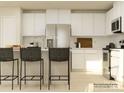 Modern kitchen features white cabinets, stainless steel appliances, and a center island with seating, perfect for entertaining at 1554 River Cane St, Edgemoor, SC 29712