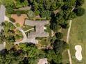 Aerial view of home on golf course, with lush landscaping at 1629 Southpoint Ln, New London, NC 28127