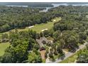 Aerial view of estate home on golf course with lake view at 1629 Southpoint Ln, New London, NC 28127