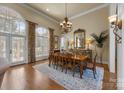 Bright dining room features a chandelier, large windows, and an elegant dining table at 1629 Southpoint Ln, New London, NC 28127
