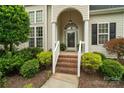 Inviting front entrance with brick steps, manicured landscaping, and a charming arched doorway at 1653 Shetland Ln, Rock Hill, SC 29730