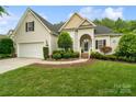 Charming home with a well-manicured lawn, two-car garage, and inviting entrance on a sunny day at 1653 Shetland Ln, Rock Hill, SC 29730