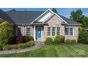 Charming brick home with a well-manicured lawn and a vibrant blue front door creating a welcoming entrance at 179 Browning Dr, Taylorsville, NC 28681