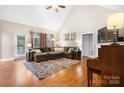 Bright living room featuring hardwood floors, a sectional sofa, and a sliding glass door at 179 Browning Dr, Taylorsville, NC 28681