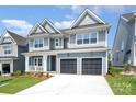 Beautiful two-story home with a covered porch and a two-car garage, showcasing modern architecture at 18019 Wilbanks Dr, Charlotte, NC 28278