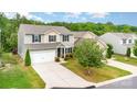 Two-story home with neutral siding, black shutters, a two-car garage, landscaping, and a mature tree at 2037 Christopher Wood Ct, Fort Mill, SC 29707