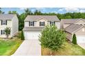 Two-story home with neutral siding, black shutters, a two-car garage, and a mature tree at 2037 Christopher Wood Ct, Fort Mill, SC 29707