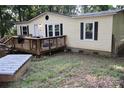 Inviting front exterior with a wooden deck, charming curb appeal, and cozy accents at 226 Lake Sylvia Rd, Lincolnton, NC 28092