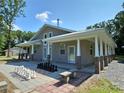 Exterior view of the home showing a covered porch with columns and chess set at 2905 Medlin Rd # 40 Acres, Monroe, NC 28112
