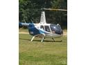 Helicopter parked on the grass, showcasing aviation access for this property at 2905 Medlin Rd # 40 Acres, Monroe, NC 28112