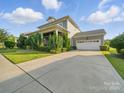 Home featuring a long driveway, and a two-car garage, nestled in a lush neighborhood at 3007 Arsdale Rd, Waxhaw, NC 28173